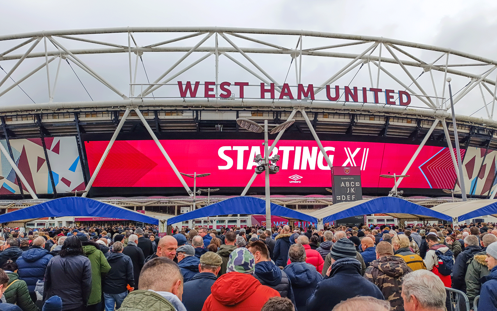 Exterior of West Ham United stadium with crowds of supporters